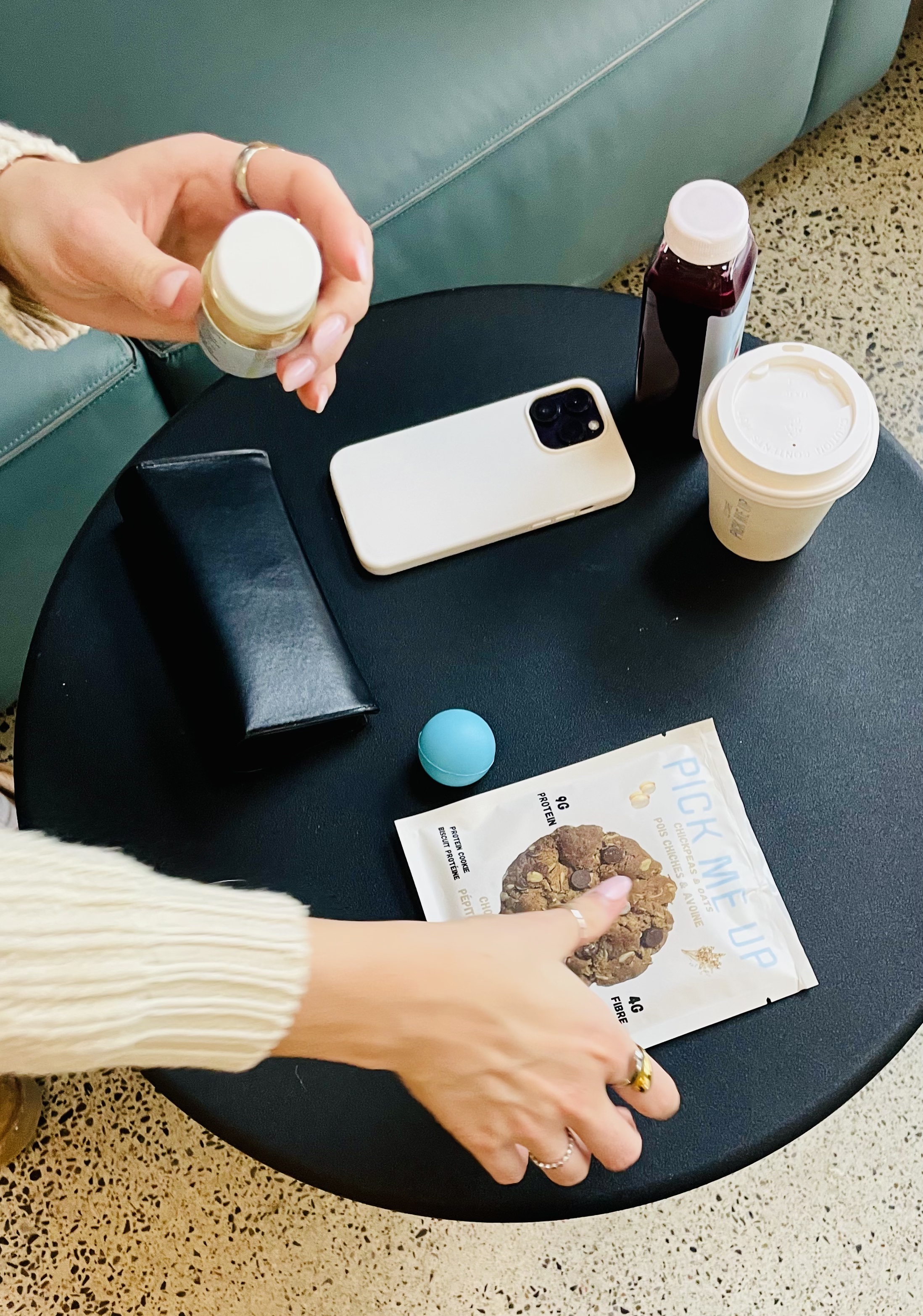 Flatlay with Pick Me Up cookie package on a table with lifestyle props