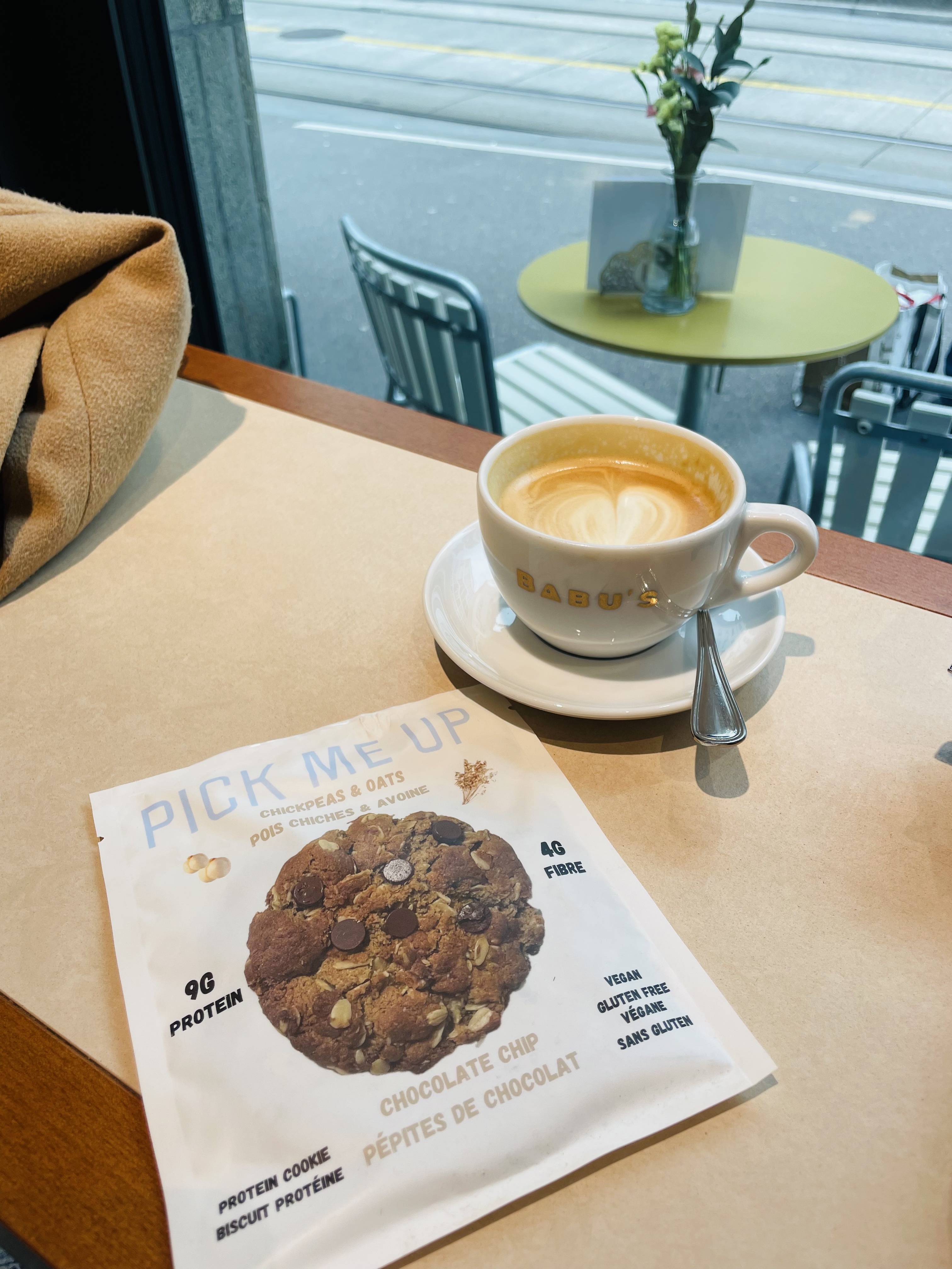 Pick Me Up cookie package next to a latte at Babu's cafe